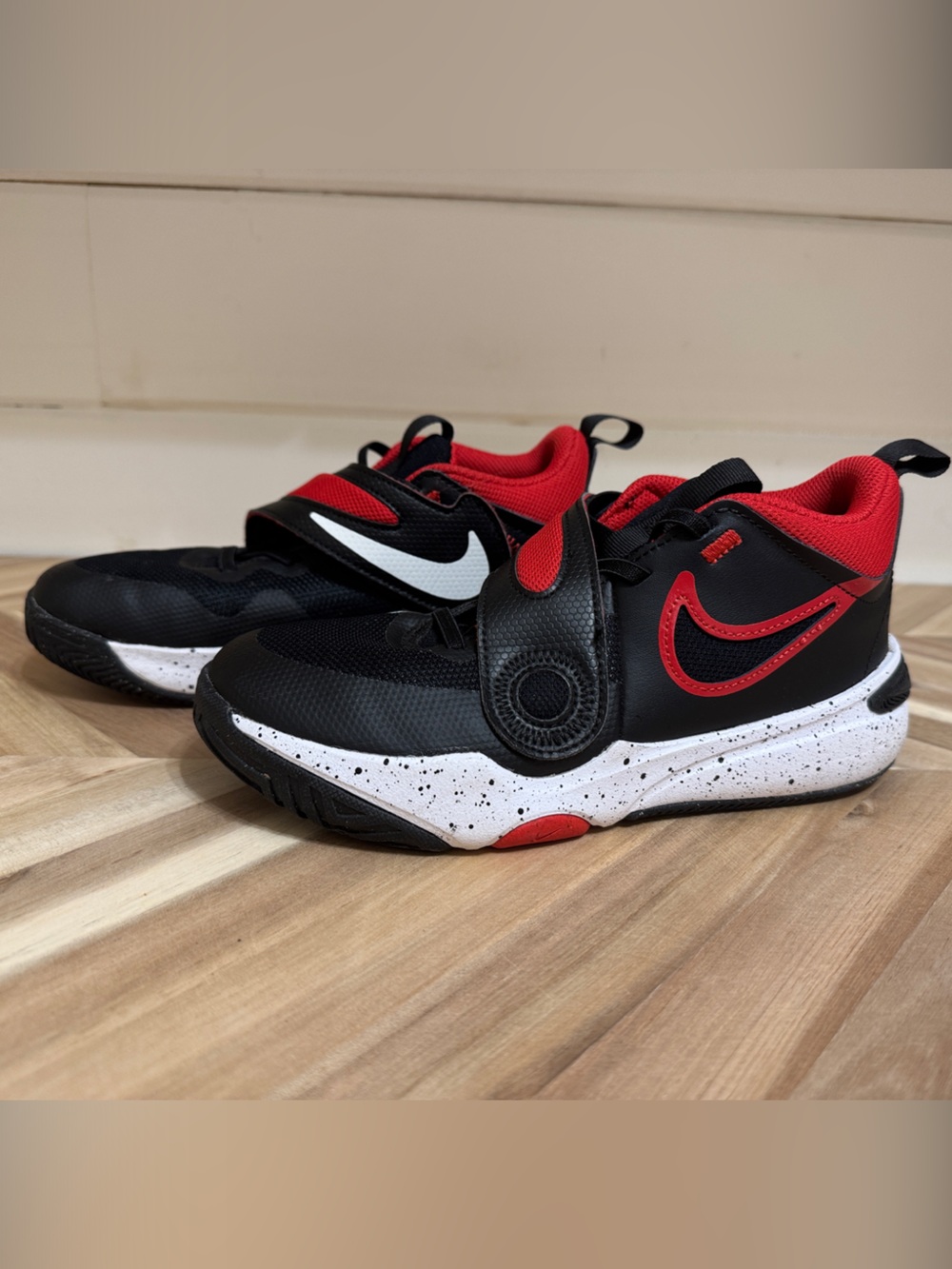 Nike “Team Hustle D 11” Kids Black, Red & White Velcro Athletic Sneakers